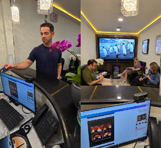 A man serving customers at a modern restaurant with digital ordering screens.