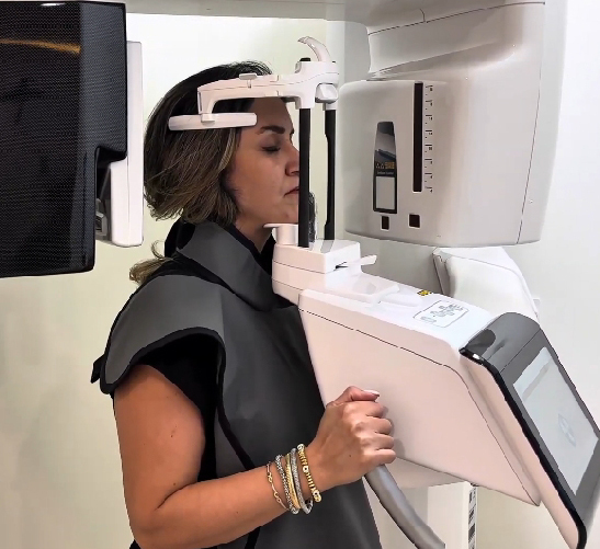 Woman undergoing a dental X-ray scan.