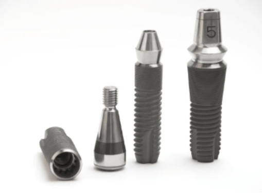 Various dental implant components arranged on a white surface.
